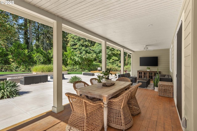 wooden deck with an outdoor hangout area and ceiling fan