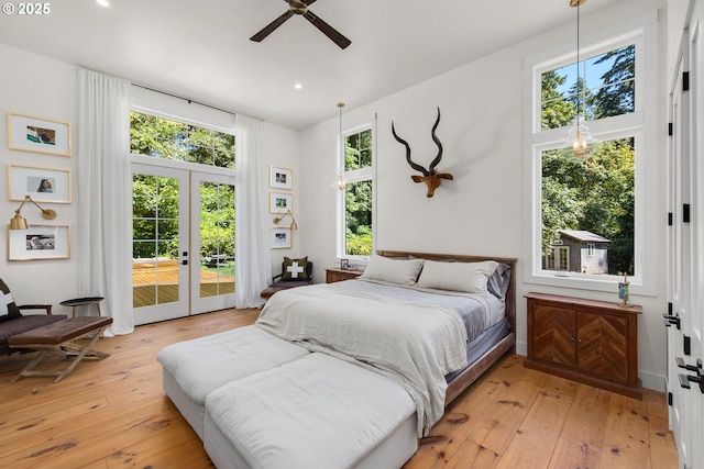 bedroom with ceiling fan, access to exterior, light wood-type flooring, and french doors