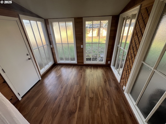 doorway to outside featuring vaulted ceiling and dark wood-style flooring