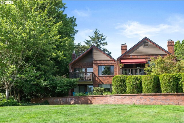 15695 SW 114th Ct Unit 4, Tigard, OR 97224 - rear view of house with a chimney, a yard, and brick siding