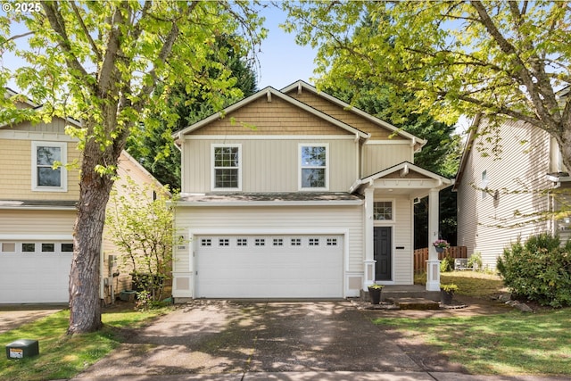 craftsman-style home featuring a garage and aphalt driveway