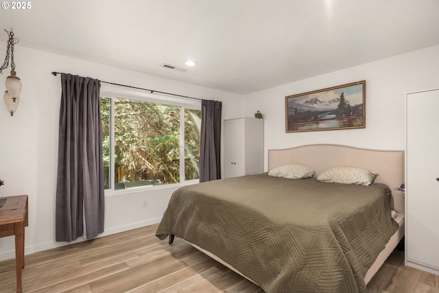 bedroom with recessed lighting, baseboards, visible vents, and light wood-style floors