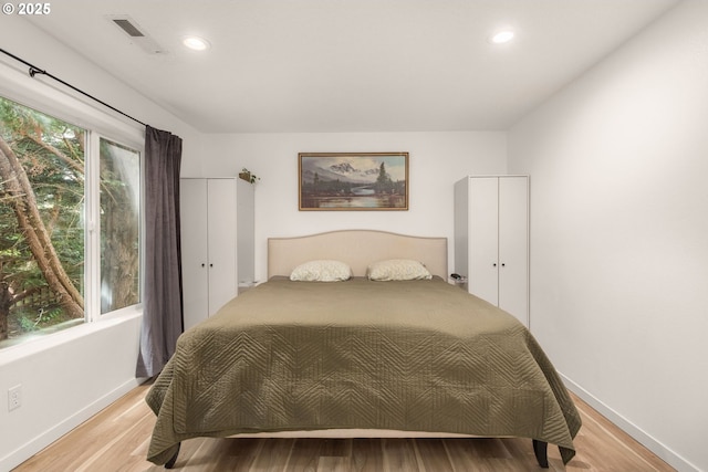 bedroom featuring recessed lighting, light wood-style flooring, and visible vents