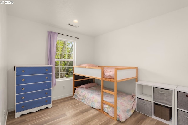bedroom with visible vents, recessed lighting, baseboards, and wood finished floors