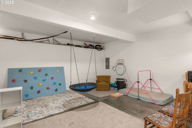 playroom featuring electric panel and concrete floors