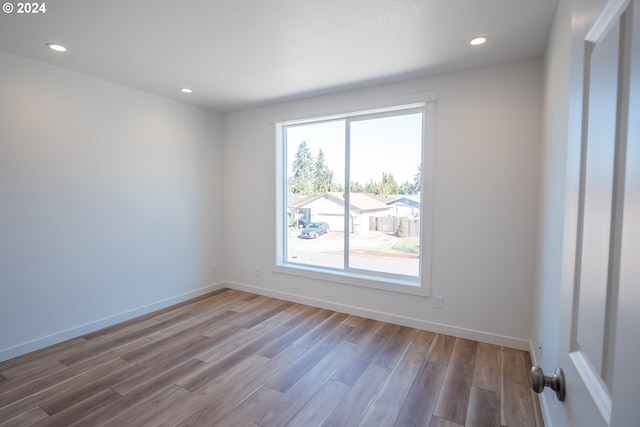 unfurnished room with hardwood / wood-style flooring