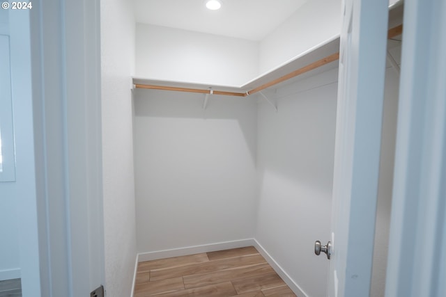 walk in closet featuring hardwood / wood-style floors