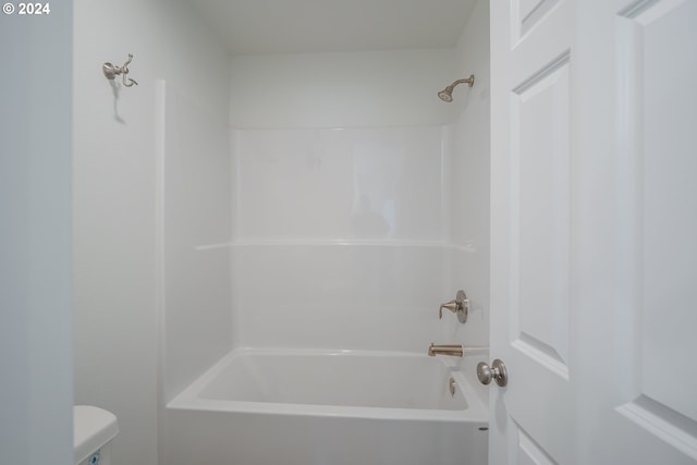 bathroom featuring shower / tub combination and toilet