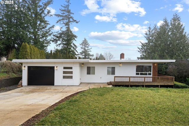 view of front of home with a front yard, a garage, and a wooden deck