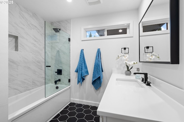 bathroom with combined bath / shower with glass door and vanity