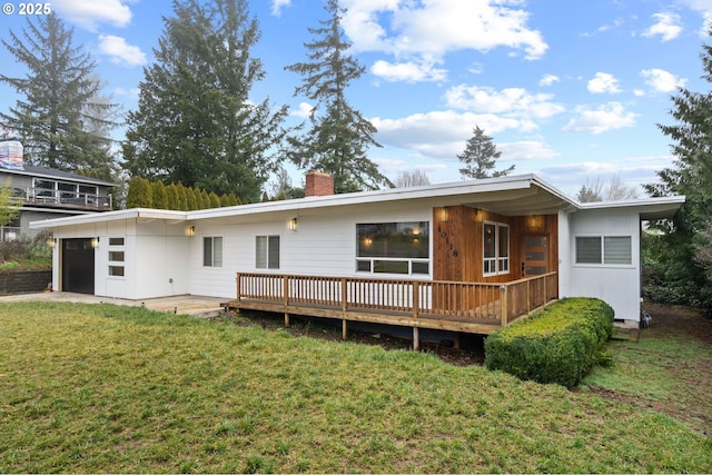 10118 SE Tyler Ct, Happy Valley, OR 97086 - back of house featuring a chimney, a garage, a yard, and a wooden deck