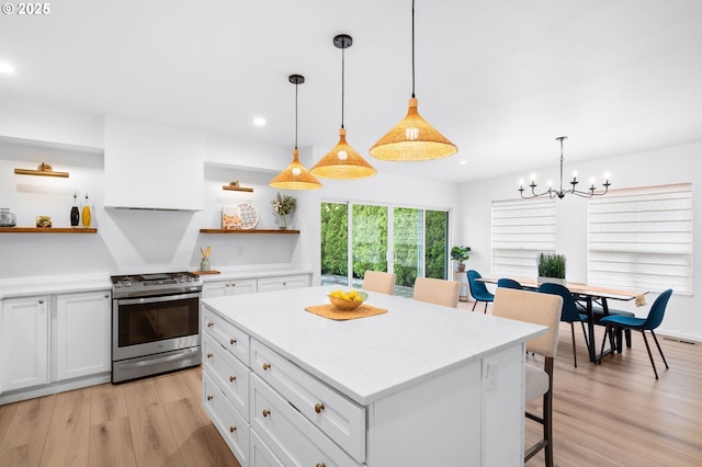 10118 SE Tyler Ct, Happy Valley, OR 97086 - kitchen with stainless steel range with gas cooktop, open shelves, light wood-style floors, white cabinets, and recessed lighting