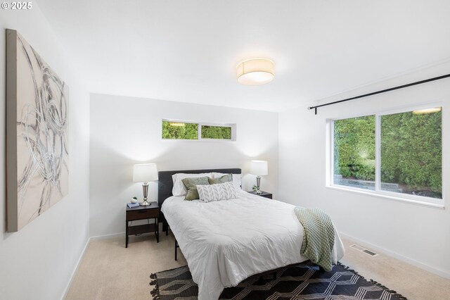 10118 SE Tyler Ct, Happy Valley, OR 97086 - bedroom with light carpet, multiple windows, and baseboards
