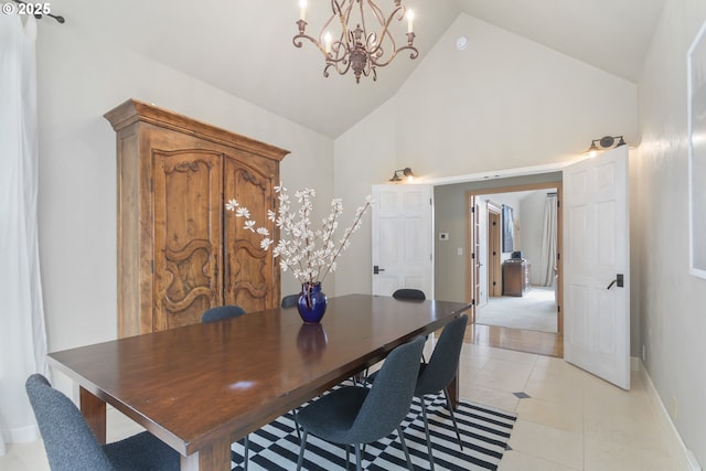 tiled dining space with an inviting chandelier and high vaulted ceiling