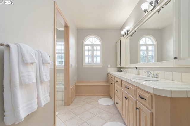 bathroom with vanity, tile patterned flooring, and a wealth of natural light