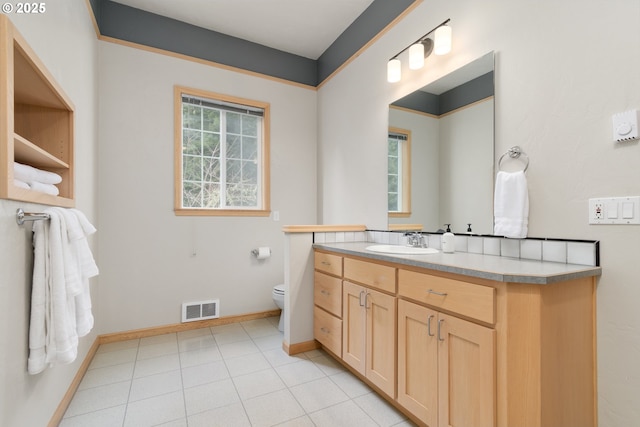 bathroom with vanity, tile patterned flooring, and toilet