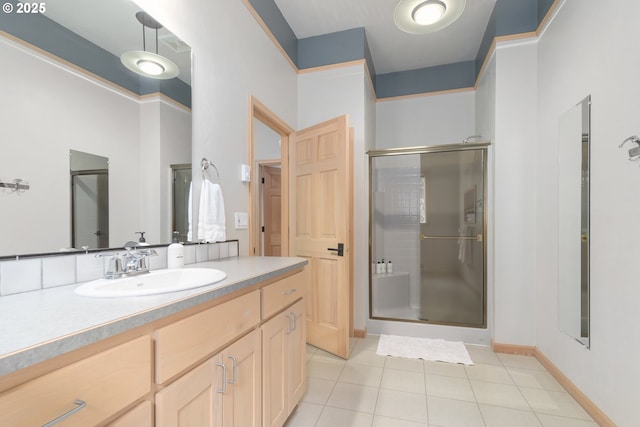 bathroom featuring vanity, a shower with shower door, and tile patterned floors