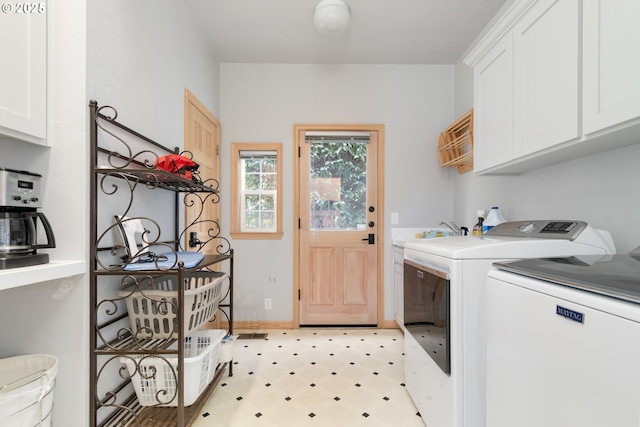 laundry area featuring sink, cabinets, and washing machine and clothes dryer