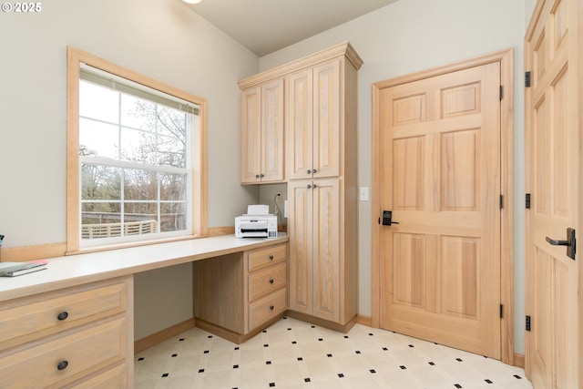 unfurnished office featuring built in desk