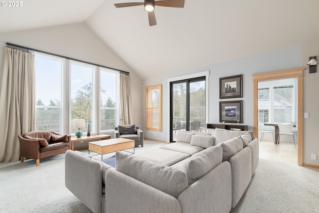 living room featuring ceiling fan, lofted ceiling, and light carpet