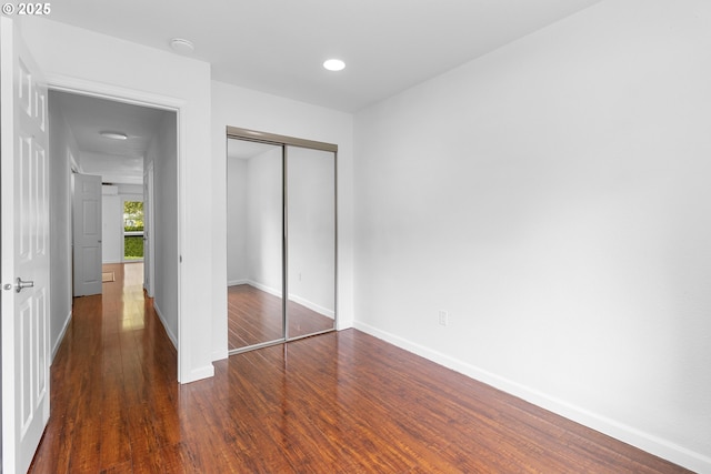 9455 SW 146th Ter Unit D 2, Beaverton, OR 97007 - unfurnished bedroom featuring wood finished floors, a closet, and baseboards