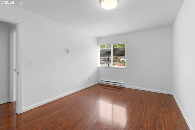 9455 SW 146th Ter Unit D 2, Beaverton, OR 97007 - spare room featuring a baseboard heating unit, wood finished floors, and baseboards