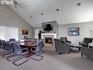 9455 SW 146th Ter Unit D 2, Beaverton, OR 97007 - dining room featuring carpet floors, a tile fireplace, a ceiling fan, and high vaulted ceiling
