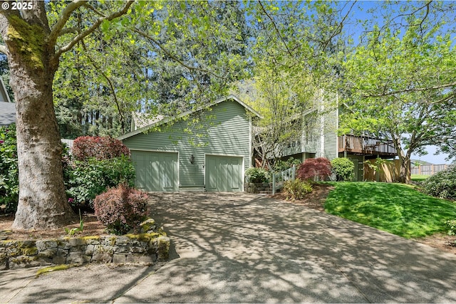 view of side of property featuring a garage and concrete driveway