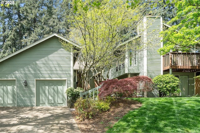 view of home's exterior with driveway, a deck, a yard, and a garage