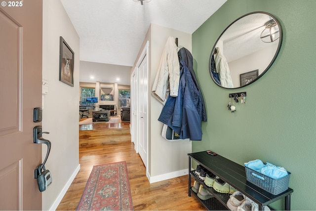 entrance foyer with light wood-style floors and baseboards
