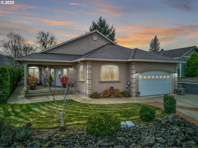 ranch-style home featuring a porch, an attached garage, driveway, a lawn, and stucco siding