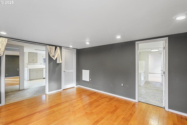 unfurnished bedroom featuring light hardwood / wood-style floors and a closet