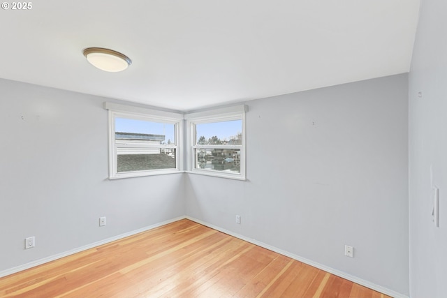 unfurnished room featuring hardwood / wood-style flooring