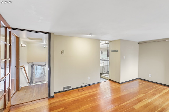 unfurnished room featuring light hardwood / wood-style flooring