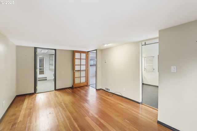 spare room featuring wood-type flooring