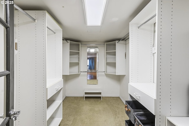 walk in closet featuring light colored carpet