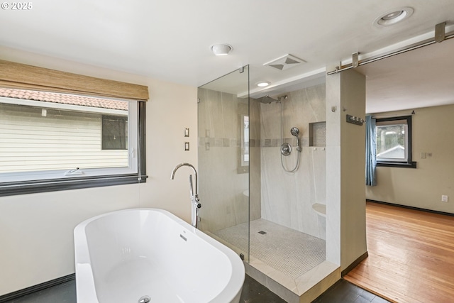 bathroom featuring independent shower and bath and wood-type flooring