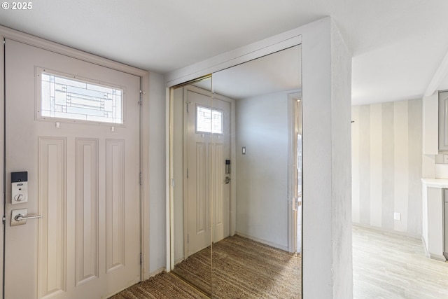 foyer entrance with light wood-type flooring