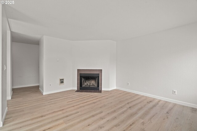 20910 Fawn Ct Unit 8, West Linn, OR 97068 - unfurnished living room featuring light wood-style flooring and a tile fireplace