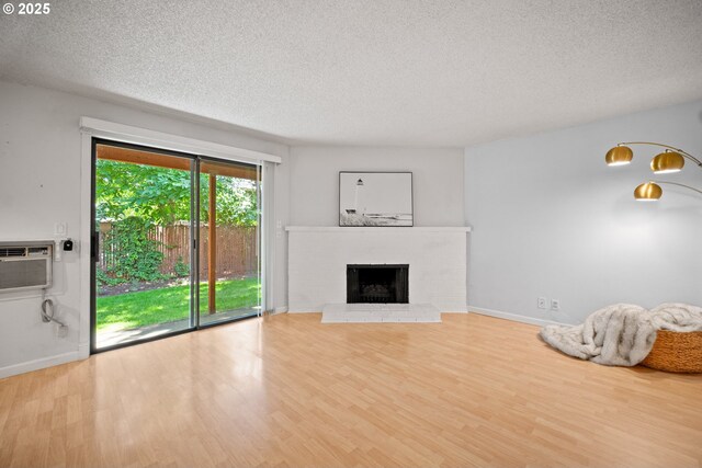 621 SE 121st Ave Unit 29, Vancouver, WA 98683 - unfurnished living room featuring a textured ceiling, wood finished floors, and a fireplace
