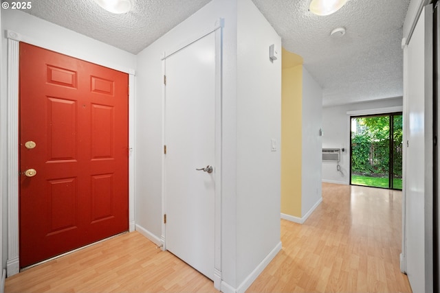 621 SE 121st Ave Unit 29, Vancouver, WA 98683 - foyer entrance featuring a textured ceiling, light wood-style floors, and a wall mounted AC