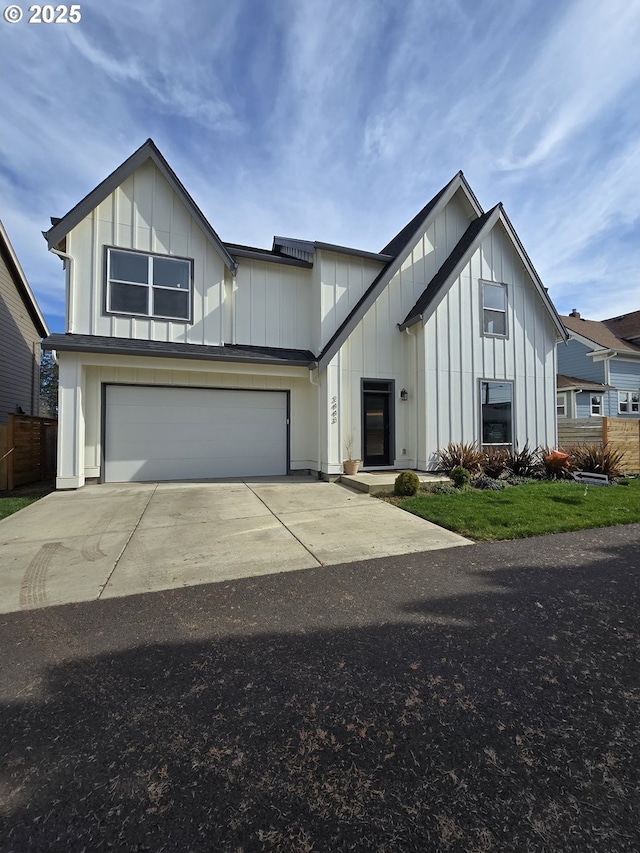 modern farmhouse style home with an attached garage, driveway, and board and batten siding