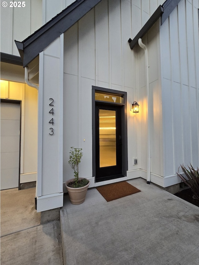 doorway to property featuring board and batten siding