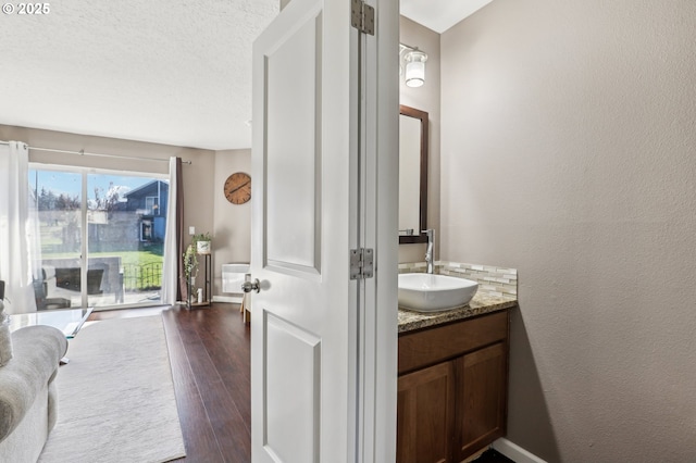 bathroom featuring vanity, hardwood / wood-style floors, and a textured ceiling