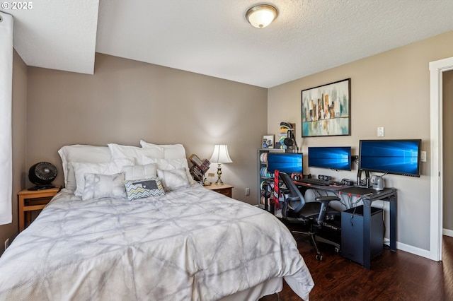 bedroom with dark wood-type flooring and a textured ceiling