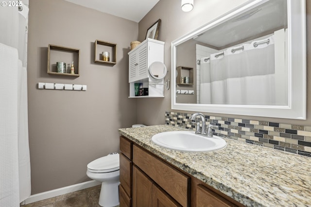 bathroom featuring vanity, decorative backsplash, tile patterned floors, and toilet