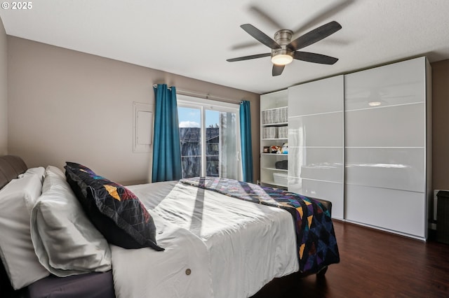 bedroom with dark wood-type flooring and ceiling fan