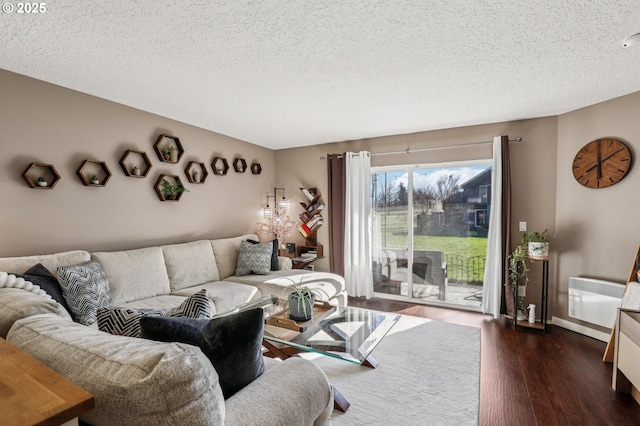 living room with dark hardwood / wood-style flooring and a textured ceiling