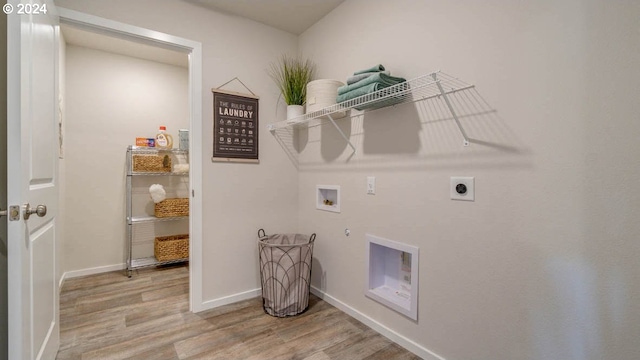 clothes washing area featuring gas dryer hookup, washer hookup, light hardwood / wood-style flooring, and electric dryer hookup