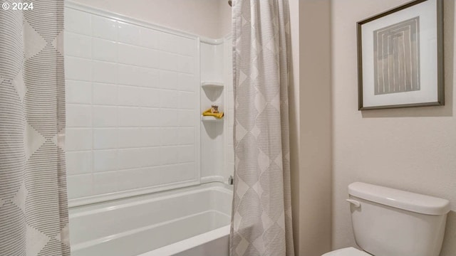 bathroom featuring toilet and shower / bath combo with shower curtain